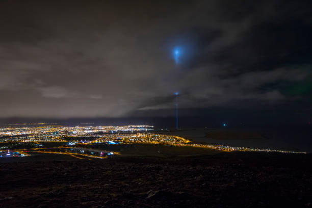 A beautiful view over the city lights of Reykjavik in Iceland.  The light of the Peace Tower can also been seen,