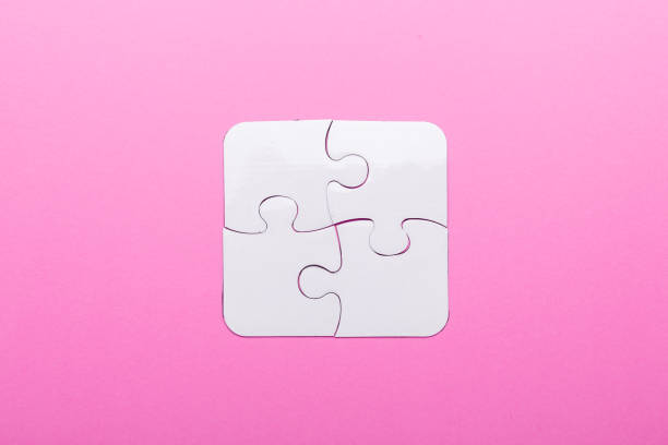 istock White puzzle on pink background. Top view 1070212956
