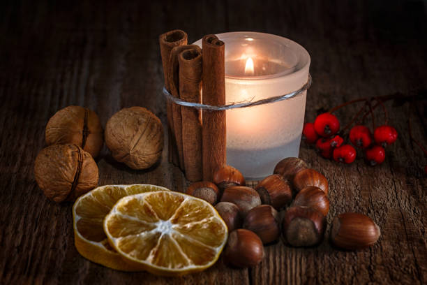istock Candlestick with cinnamon, nuts and dry lemon slices 1070213390