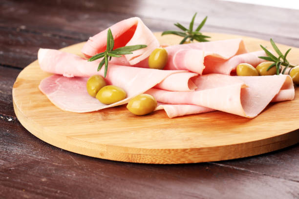 istock Sliced ham on wooden background. Fresh prosciutto. Pork ham sliced. 1070224334