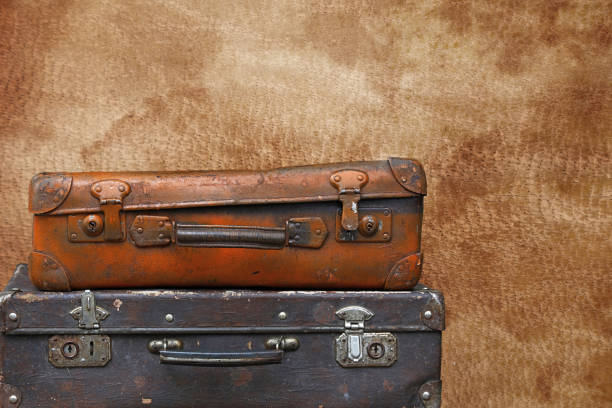 istock Old vintage travel suitcases over brown leather 1070224752
