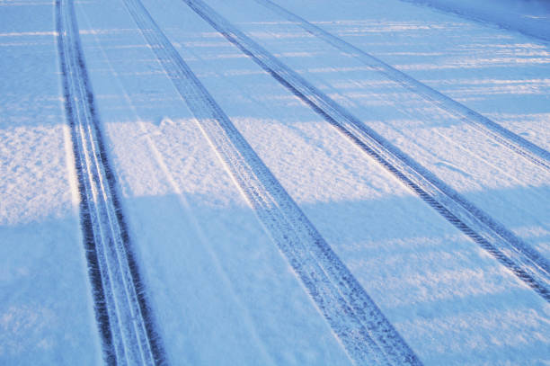 istock Car Tire Tracks in the Winter Snow 1070225722