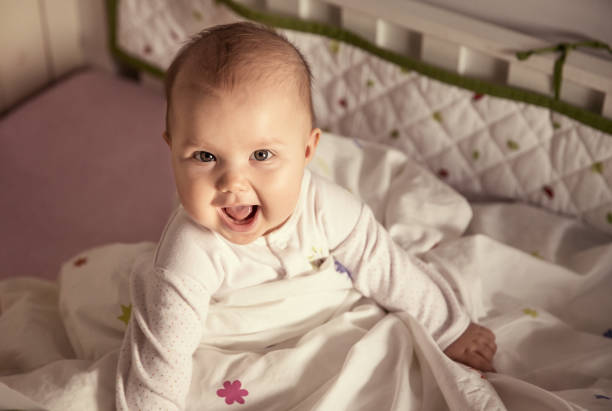 istock Cute baby sitting in a bed 1070233568