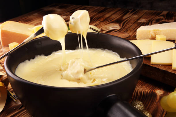 istock Gourmet Swiss fondue dinner on a winter evening with assorted cheese 1070234916