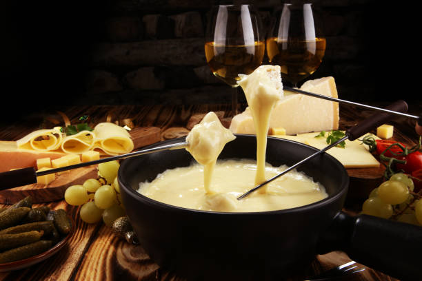 istock Gourmet Swiss fondue dinner on a winter evening with assorted cheese 1070235318