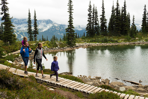 Four person family enjoying a hike in the mountains