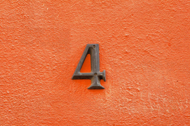 istock House address number 4 and orange colored wall 1070242762