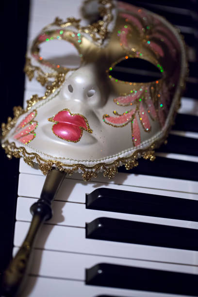 Masked person with gray background in carnival