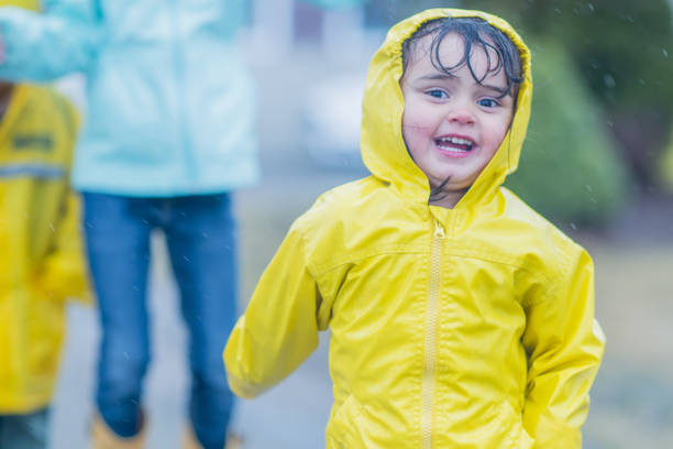istock Happy children playing in the rain 1070257168