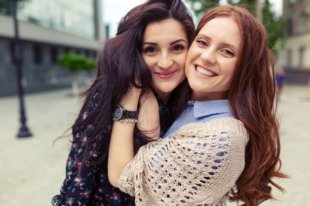 istock Carefree smiling sisters hugging and having fun together 1070257722