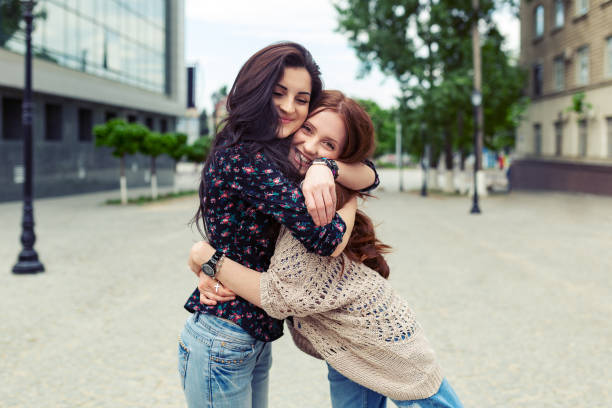 istock Carefree smiling sisters hugging and having fun together 1070257726