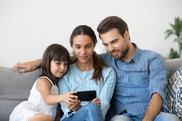 istock Family spend free time watching video on mobile phone 1070261802