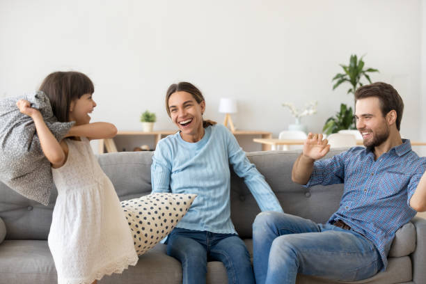 istock Happy family have fun fighting with pillows 1070261866