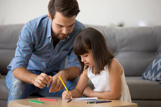 istock Father and daughter drawing together at home 1070261876