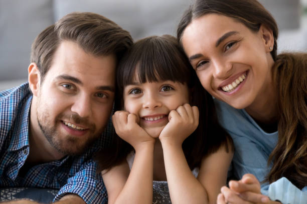 istock Diverse family lying on warm floor looking at camera 1070261912