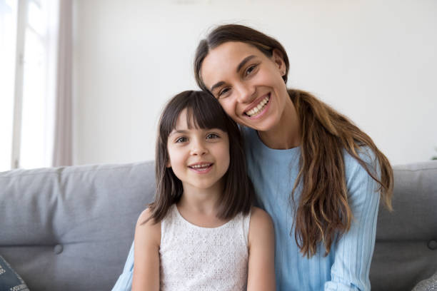 istock Daughter and mother have video call smiling looking at camera 1070262050