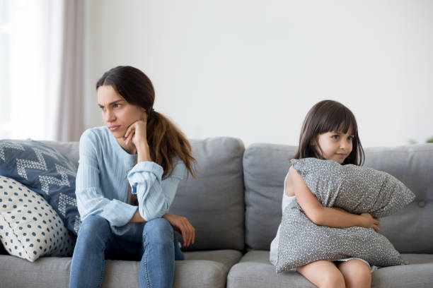 istock Daughter and mother after quarrelling sitting on couch 1070262144