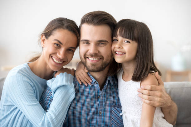 istock Father mother and little daughter looking at camera 1070267236