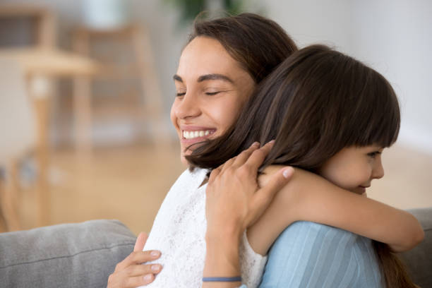 istock Candid mother hugging daughter expressing love and devotion 1070267324