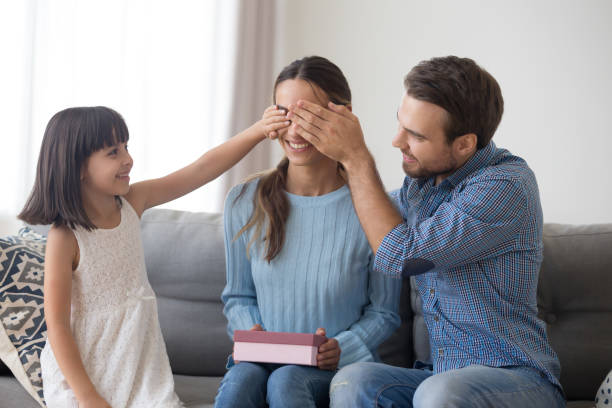 istock Daughter father prepare for mother a gift closed her eyes 1070267436