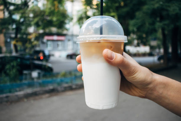 istock Hand holding coffee latte in plastic transparent cup 1070267948