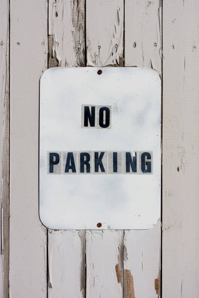 istock Old No Parking sign on a worn fence 1070271474