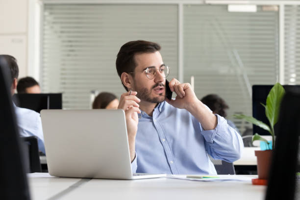 istock Entrepreneur making call consulting client speaking by cell in office 1070271682