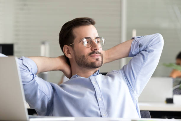 istock Relaxed businessman taking break holding hands behind head enjoying rest 1070271704