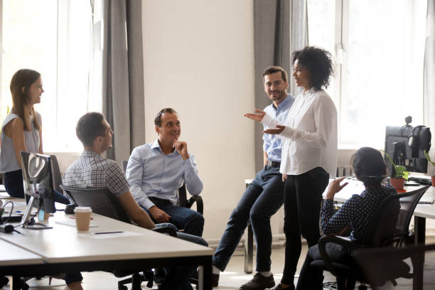 istock Smiling african coach speaking at diverse corporate group meeting 1070271736