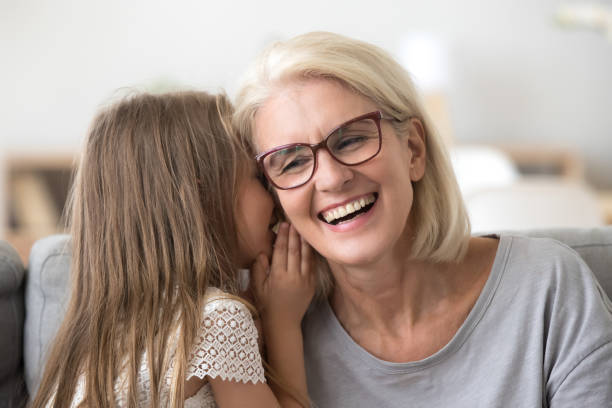 istock Granddaughter whisper something to granny sharing secret 1070272134