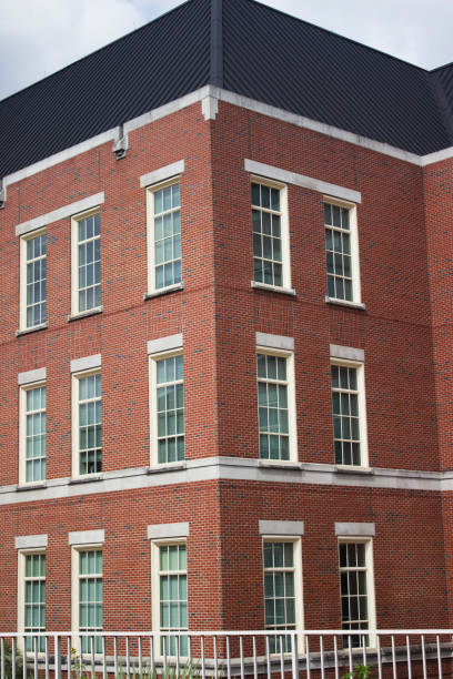 istock Architectural brick building with blue roof and white fence 1070275518