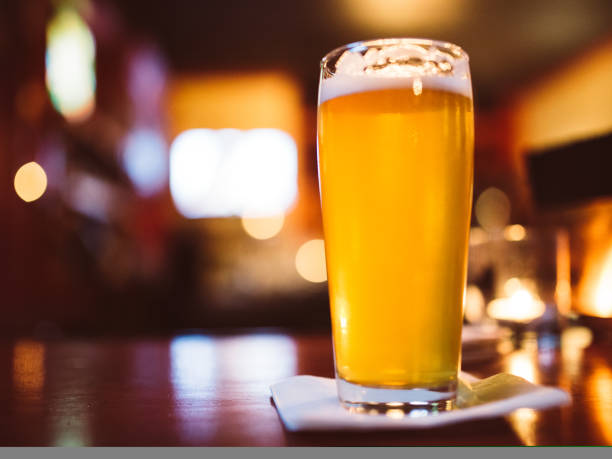 istock Glass of Beer, Pub Bar Counter Restaurant Interior Blurry Background 1070288004