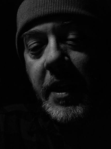 istock Bearded Man Wearing Hat in the Shadows Face Portrait 1070288140
