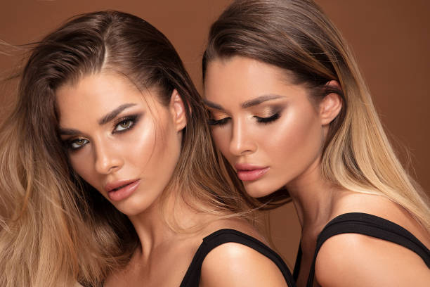 istock Two attractive twins women in glamour makeup 1070290790
