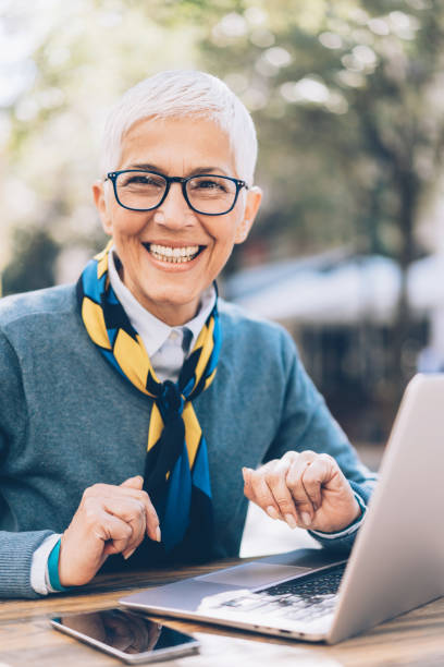 istock Smiling Senior Woman Working on Laptop 1070298868