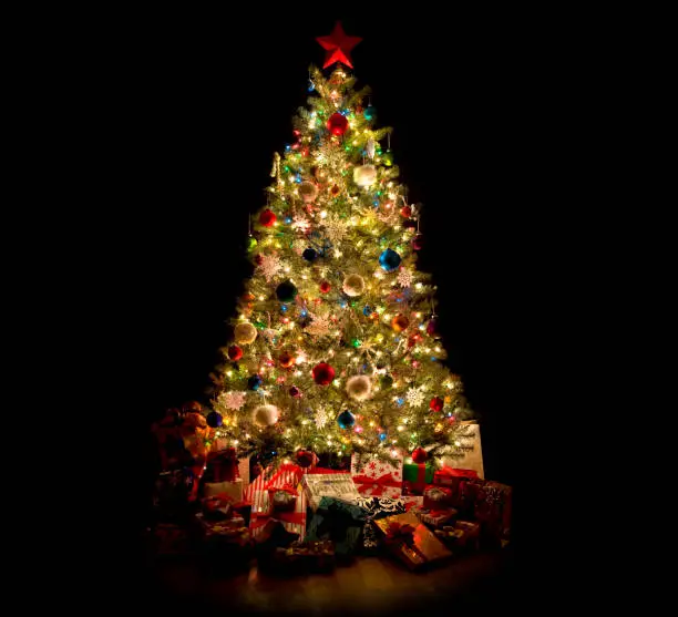 Photo of Christmas Tree with Decorations, Ornaments and Gifts Isolated on Black