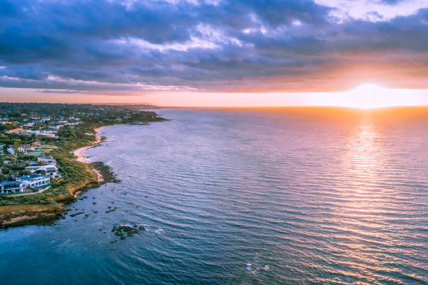 istock Sunset over ocean near coastline aerial view 1070310730
