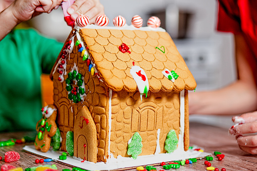 A gingerbread house surrounded by Christmas cookies