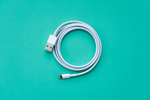 White Spiral USB Cable Isolated on Turquoise Background Top View