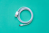 White USB Cable on Turquoise Background Top View