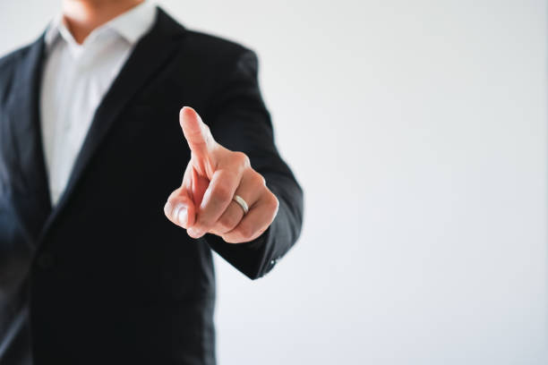 istock Young business man pointing finger touching on screen on white background. 1070324516