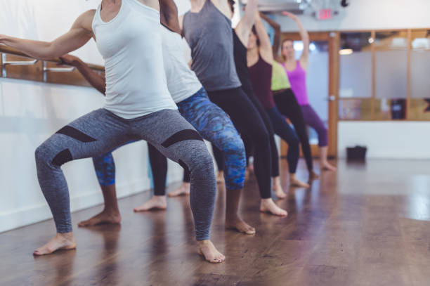 istock Instructor leads a multiethnic group of women through a barre workout 1070324802