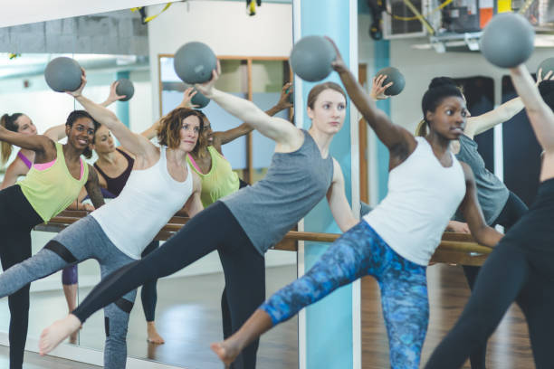 istock Instructor leads a multiethnic group of women through a barre workout 1070324822