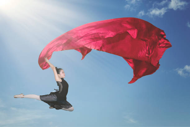 istock Ballerina dancing with a red fabric in the sky 1070335252