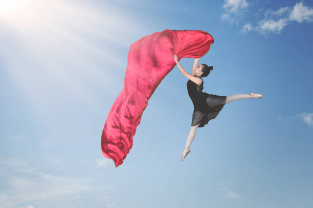 istock Ballet dancer dancing with fabric in the sky 1070335266