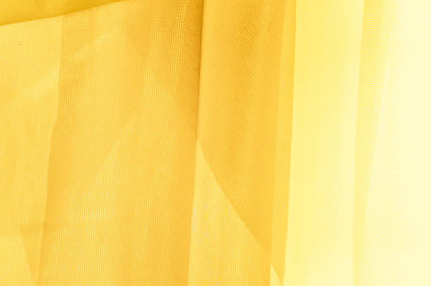 istock Texture, background, pattern. The texture of the silk fabric is yellow. Silk fabric is transparent. 1070337922
