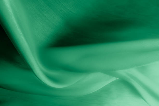 istock Texture, background, pattern. Pale green silk fabric. It is very soft and thin tulle, soft silk tulle. Looks like a drapery, much softer than a wedding illusion 1070349048