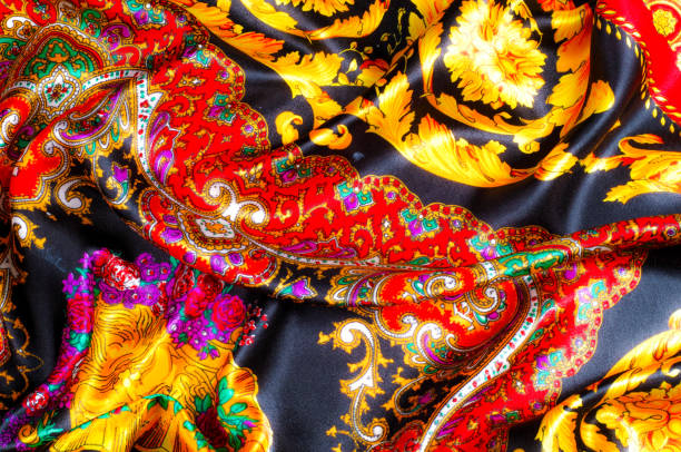 istock Background texture, drawing. Silk fabric. Fabric with bright patterns of yellow and red colors, Indian fabric, silk fabric around the yard, printed silk, printed fabric Sanganery 1070353530