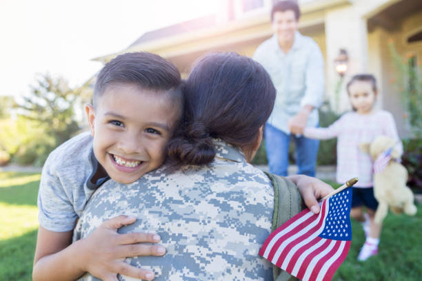 istock Excited young boy hugs military mom 1070362248
