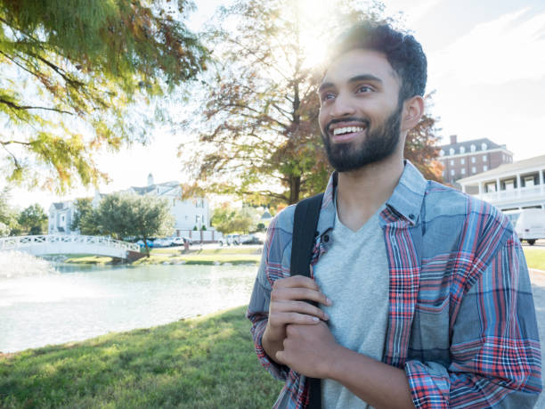 istock A young, college student smiles on walk around campus 1070362352